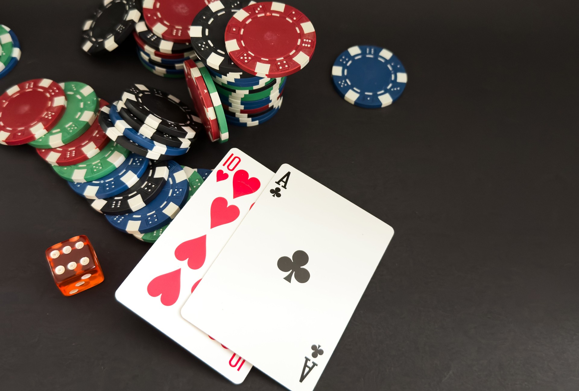 A gambling game of poker with a winning combination of straight flush. Cards with chips on a blue table in a poker club. Advertising space.