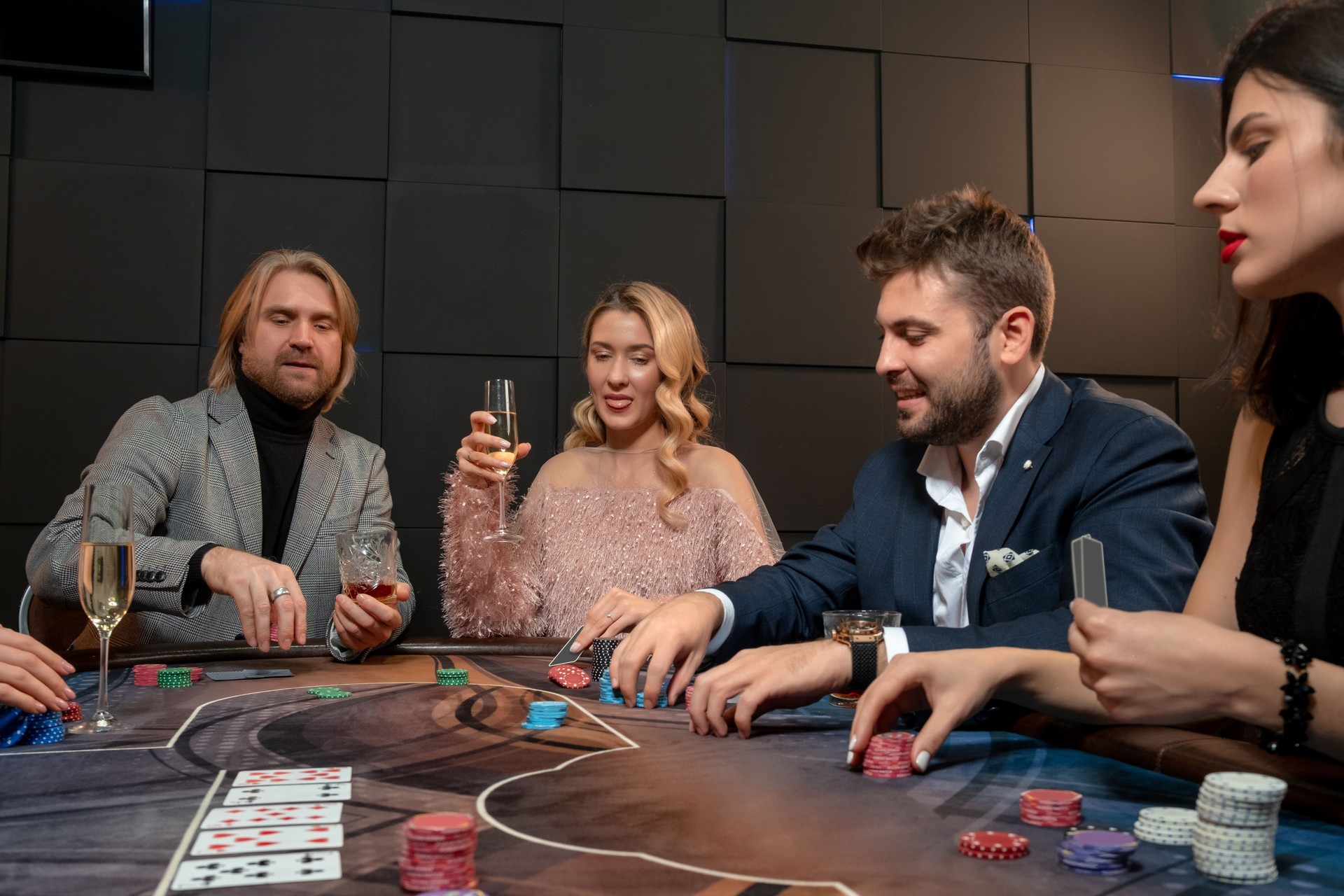 Interested male and female poker players making bets at gaming table